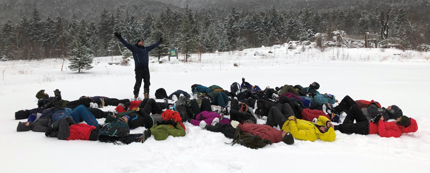 group picture outside lying in snow