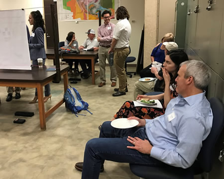 people eating while watching poster presentations