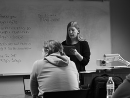 student standing in front of class