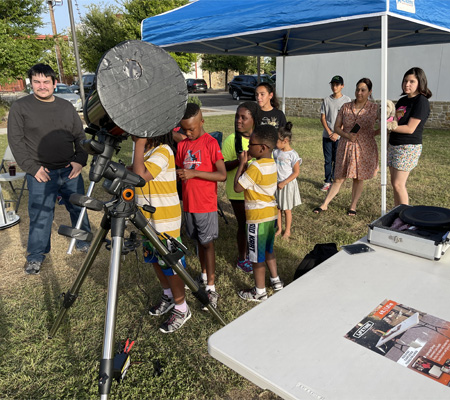 children looking through telescope