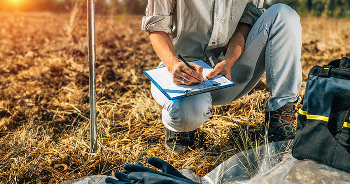 person recording data in the field