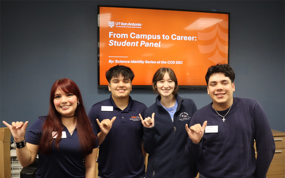 four SSC students doing roadrunner hand sign