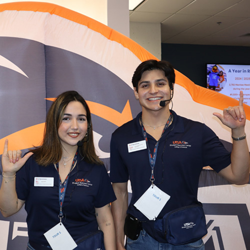 two SSC students doing roadrunner hand sign