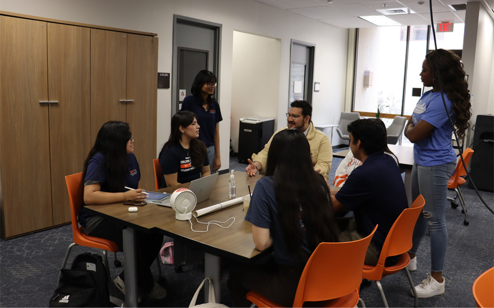 students and mentor seated at table