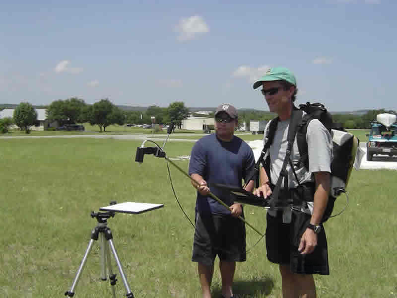 two researchers checking equipment