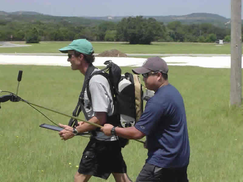 two researchers walking across field