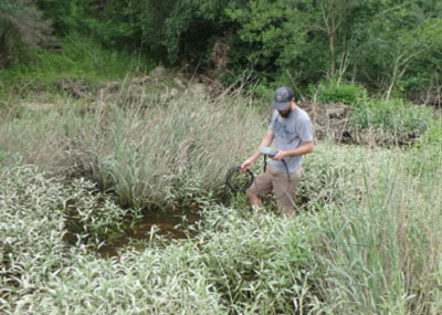 student in creek