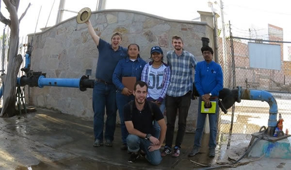 Peter and company in front of an urban well