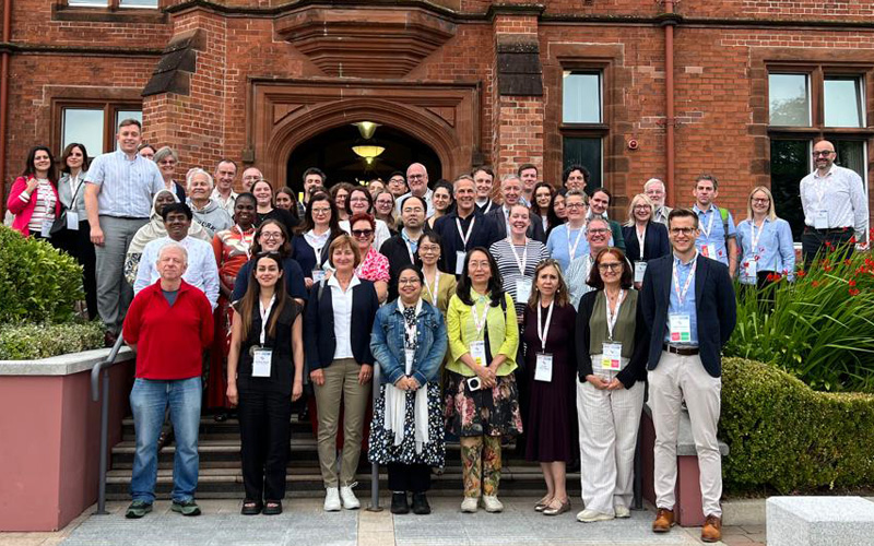 group picture in front of Queens University