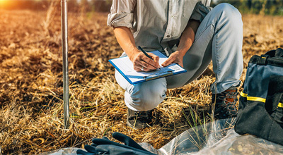 person recording data in the field