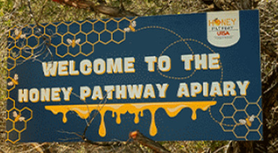 students and HONEY Pathway Apiary sign