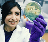 student holding petri dish