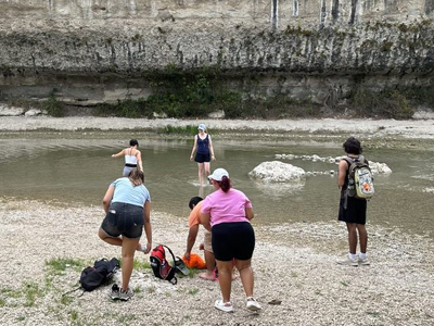 students on river bank