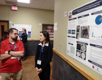Paulina Quinonez presenting her poster to Dr. Matthew Barnes