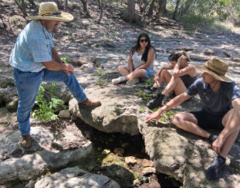 Scott Gardner and students in woods