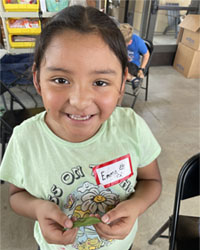 camper holding a leaf with a caterpillar