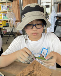 camper holding a leaf with a caterpillar