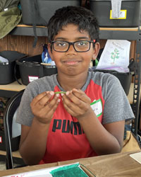 camper holding a leaf with a caterpillar