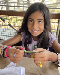 camper holding a leaf with a caterpillar