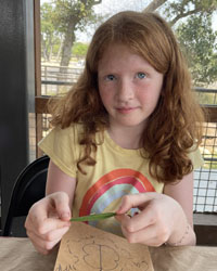 camper holding a leaf with a caterpillar