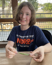 camper holding a leaf with a caterpillar