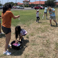 campers playing with water balloons