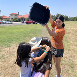 camper dumping water on other campers