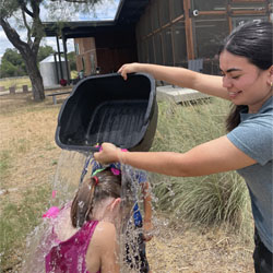 camper dumping water on another camper