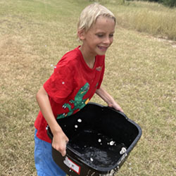 camper carrying bucket of water