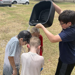 camper dumping water on other campers