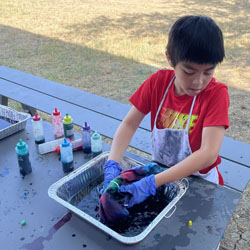 camper making tie dye shirt