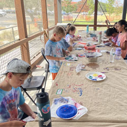 campers painting paper plates