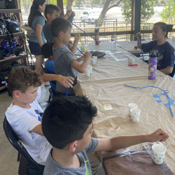 campers making bead fish keychains