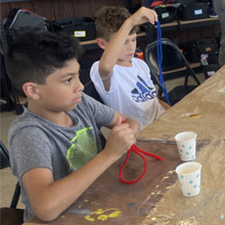 campers making bead fish keychains