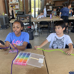 campers making bead fish keychains