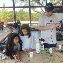 campers making bead fish keychains