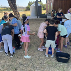 campers working with sand to create rivers