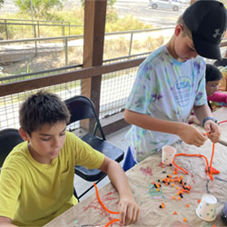 campers making bead fish keychains