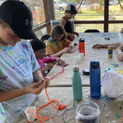 campers making bead fish keychains