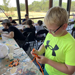 camper making bead fish keychain