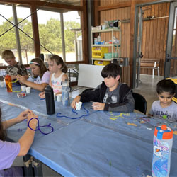 campers making bead fish keychains