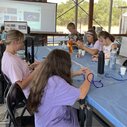 campers making bead fish keychains