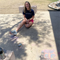 counselor sitting by chalk designs