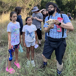 Julian explaining animal skull to campers