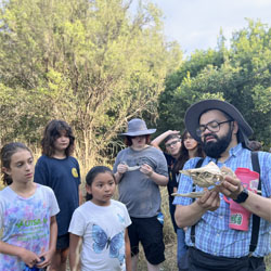 Julian explaining animal skull to campers