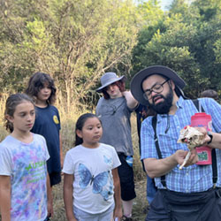 Julian explaining animal skull to campers