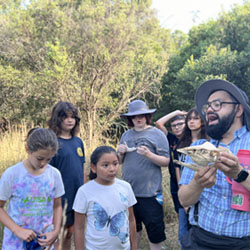 Julian explaining animal skull to campers