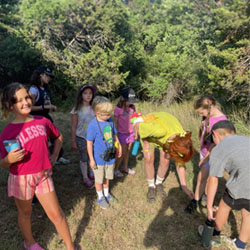 campers looking at something on the ground