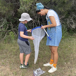 camper examining insect net