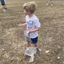 camper catching insects with net